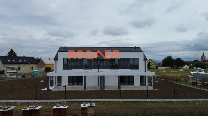 Stavba střechy na novém moderním dvojdomě (pokládka střešních panelů Klik Retro Plus RAL 7016 Mat) ve Slaný